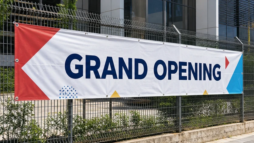 Outdoor banner secured to a commercial fence