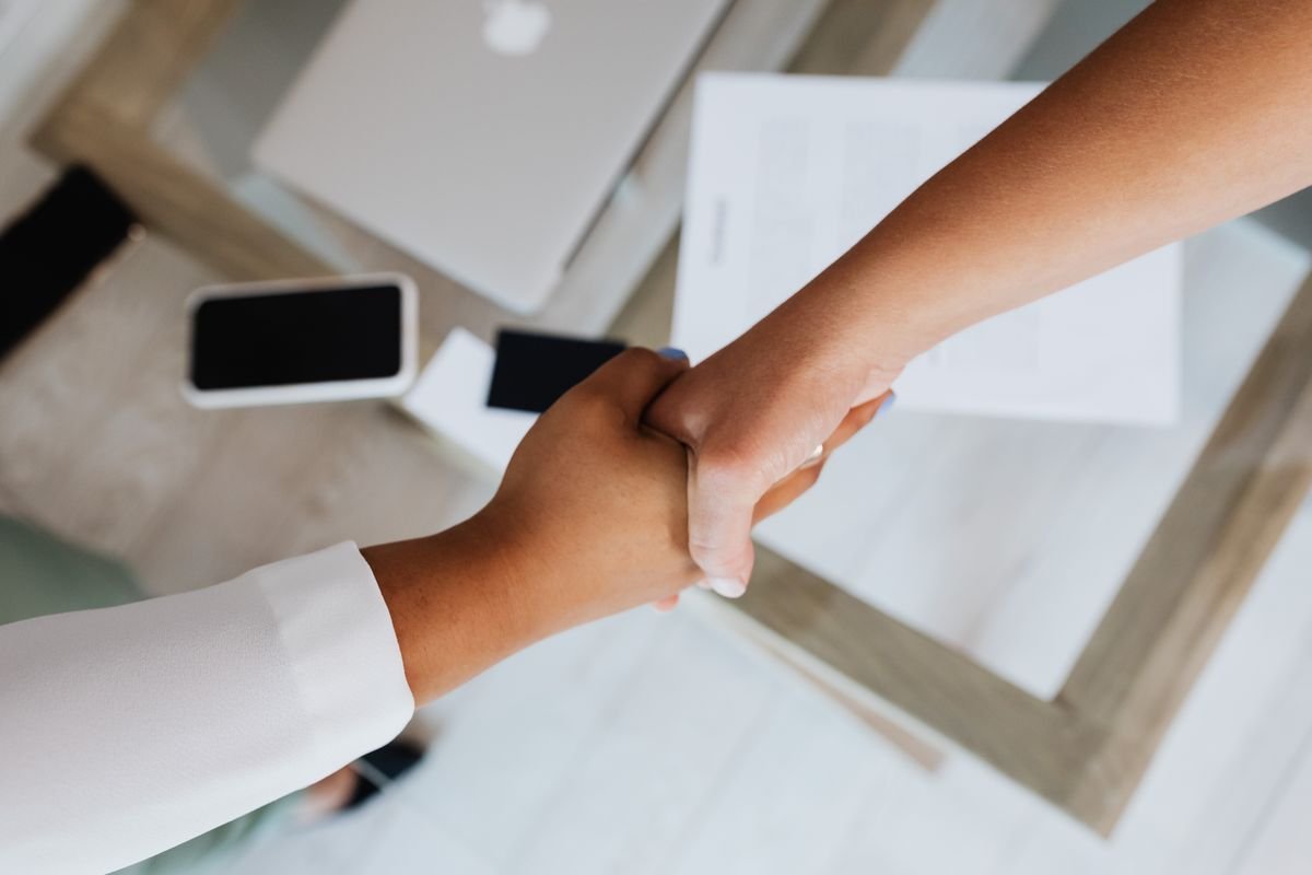 Business handshake across an office desk