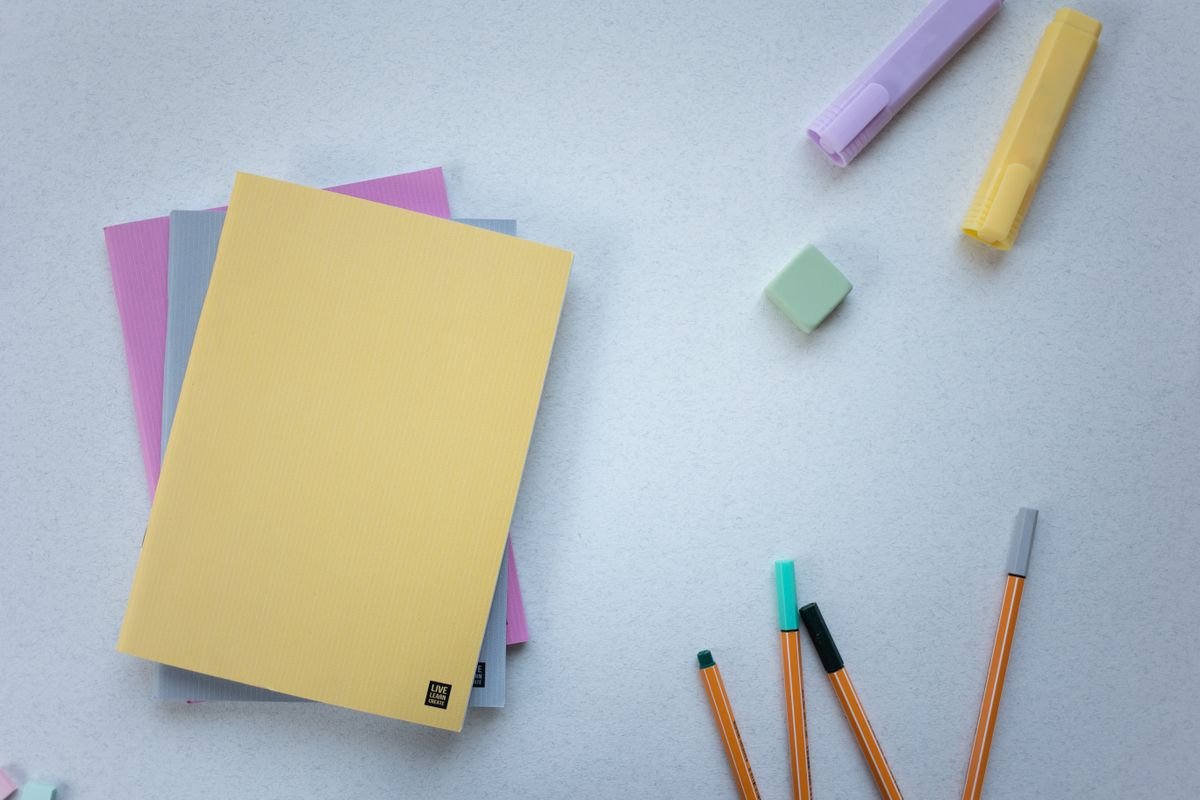Colourful notebooks and markers on a desk
